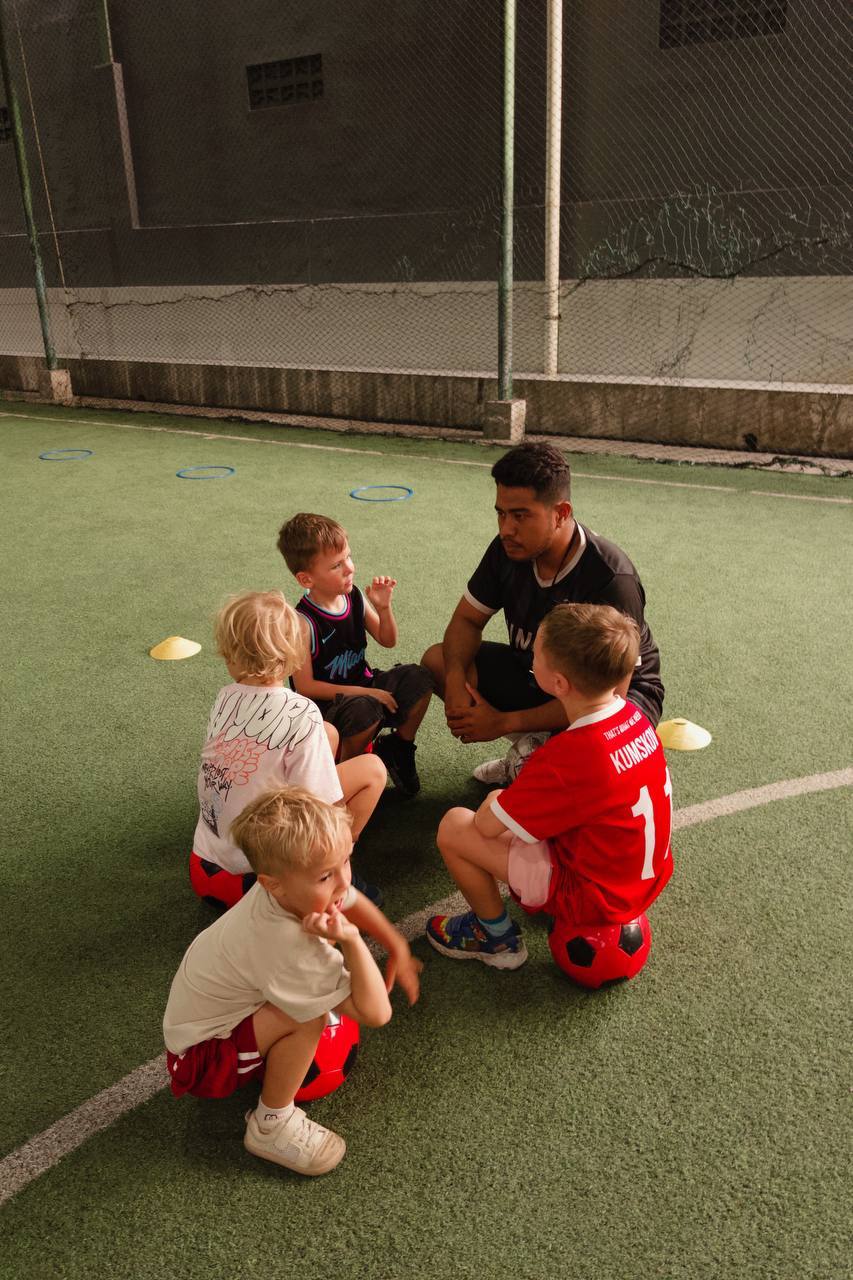 Ronaldo, coach at UNITY Football Bali, talking with young players
