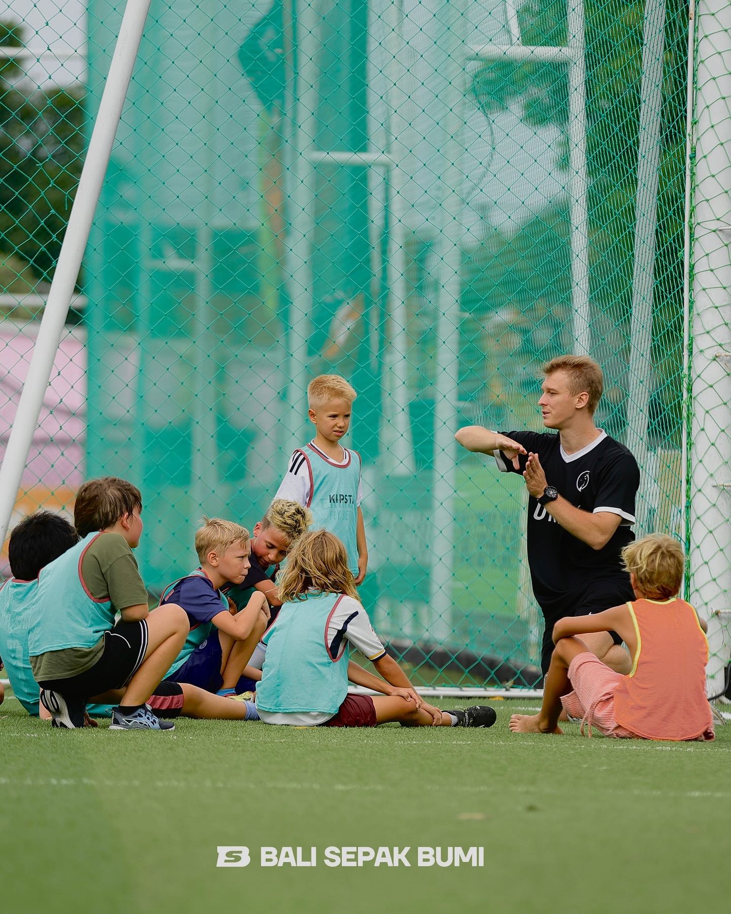 UNITY Football Bali coach talking to a group of young players