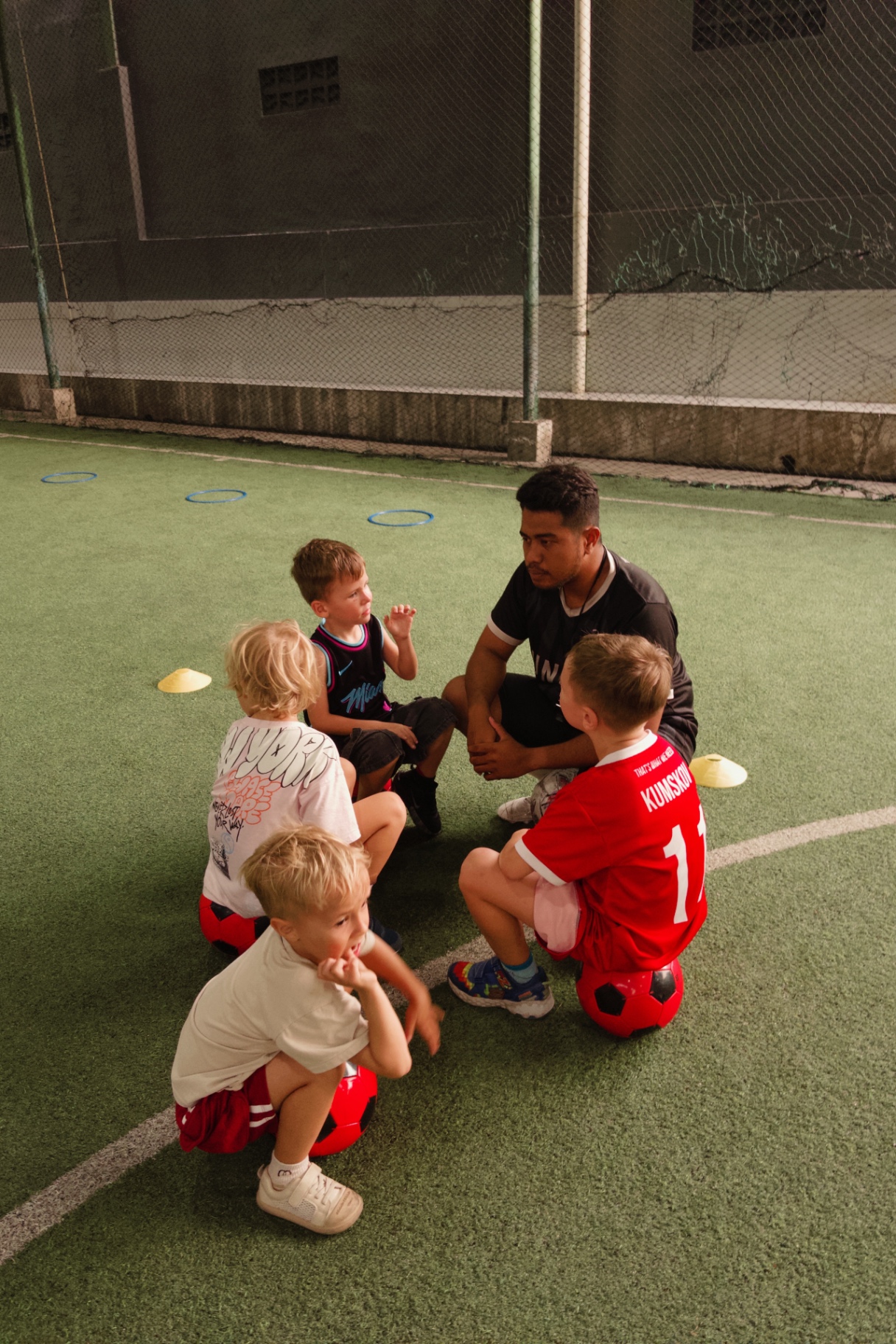 Coach talking to young players wearing UNITY kits